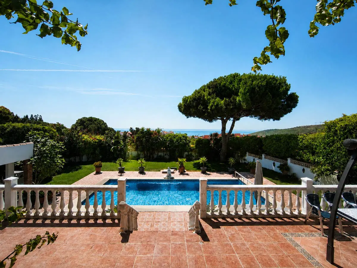 Pool and garden with sea views at the villa in Manilva